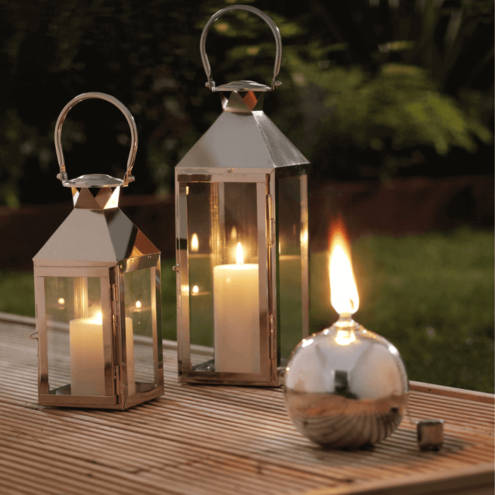 WADE BUILDING SUPPLIES | HURRICANE CANDLES ON GARDEN DECKING WITH THREE CANDLES
