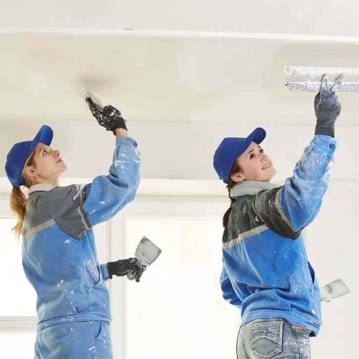 WADE BUILDING SUPPLIES | TWO FEMALE WORKERS PAINTING A WHITE CEILING STOOD ON A PLATFORM